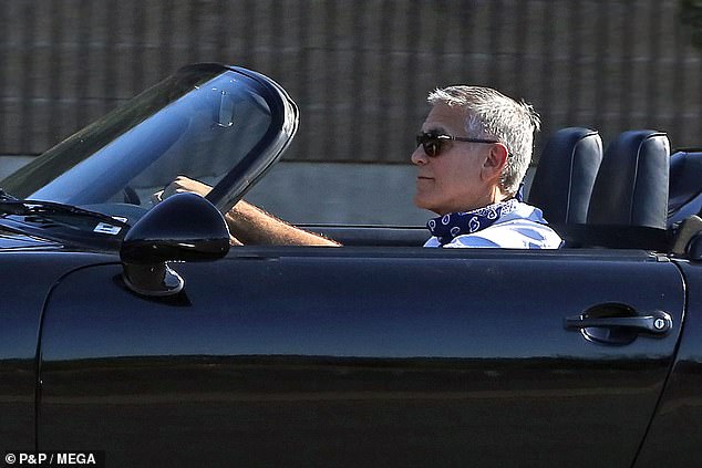 George Clooney fansite blog 27646948-8257213-Casual_He_had_on_a_pale_blue_shirt_with_the_sleeves_rolled_up_an-a-32_1587854345584
